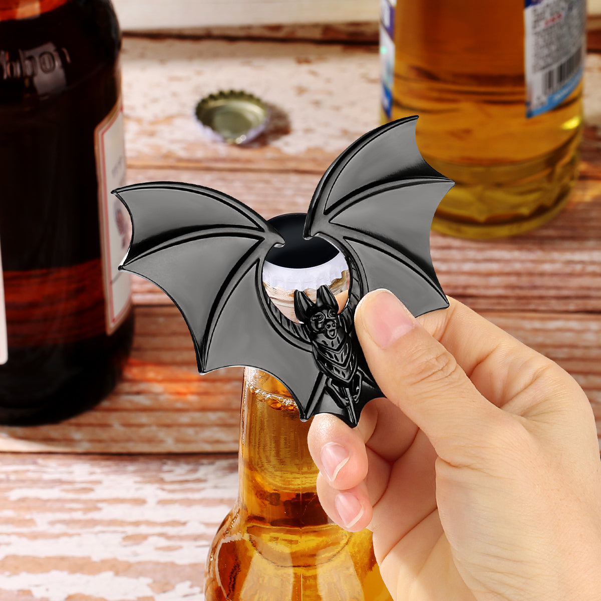 Bat bottle opener used to open a cold beer bottle at a spooky-themed party